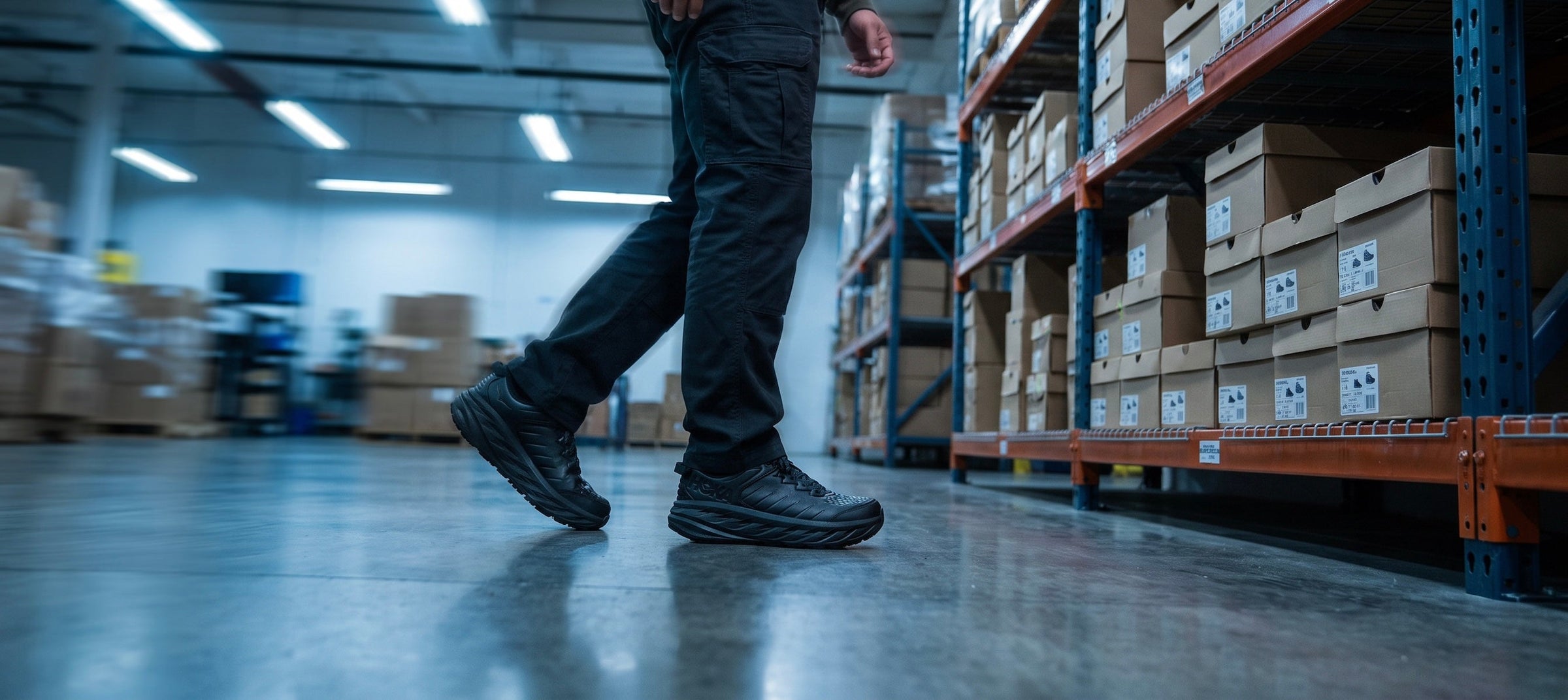 warehouse worker wearing Hoka black bondi SR shoes on concrete floors