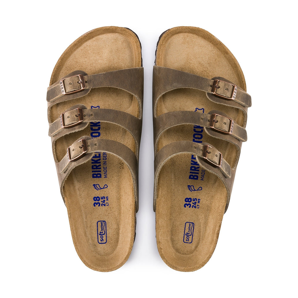 Pair of brown BIRKENSTOCK Women's Florida Soft Footbed Birkenstock sandals on a white background