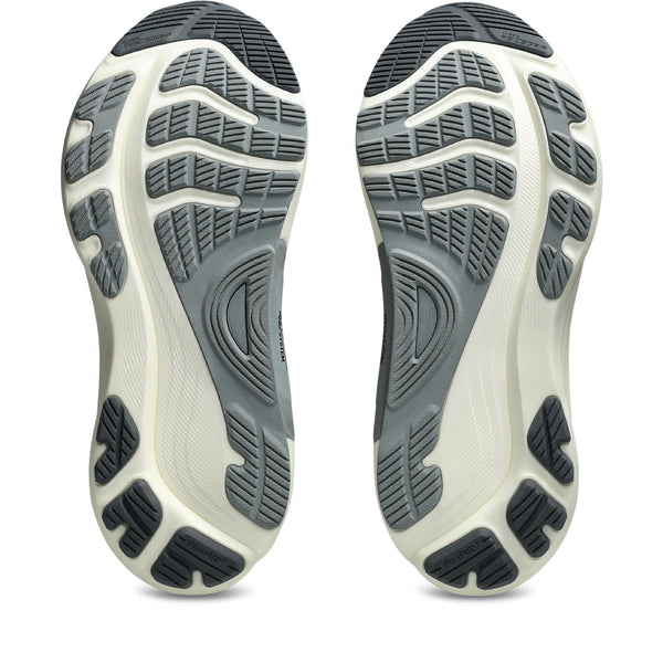 Close-up of a pair of Gel-Kayano 32 shoes with textured soles on a white background.