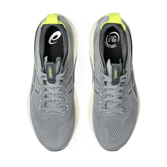 A pair of ASICS Gel-Kayano 32 running shoes in gray with bright neon yellow accents on the tongue pull tabs and heel collar, shown from a top-down view on a white background.