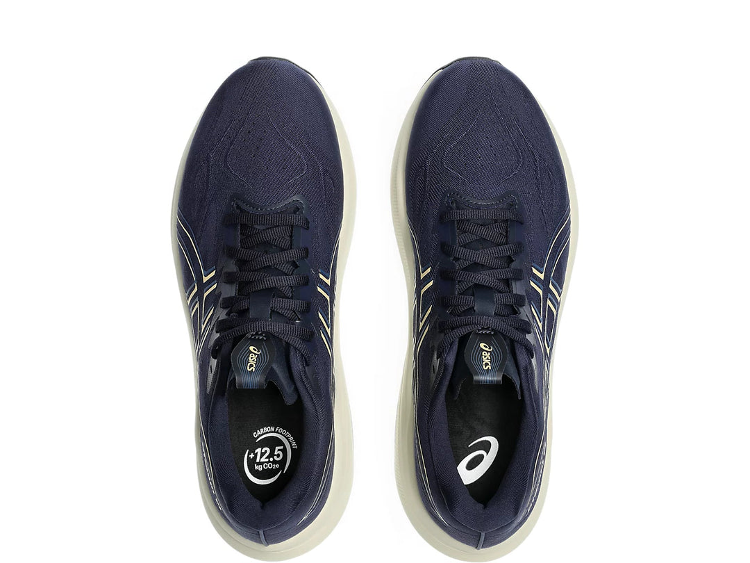 Pair of navy blue running shoes with white soles on a white background