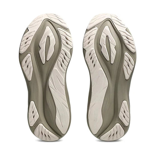 A pair of athletic shoes shown from the sole view, featuring a dual-tone design with a muted olive green and off-white textured tread pattern, set against a plain white background.