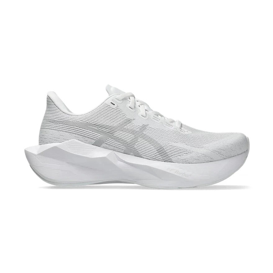 Novablast 6 a women's white athletic running shoe with a textured knit upper and a thick sculpted white sole, shown in a side profile on a clean white background.