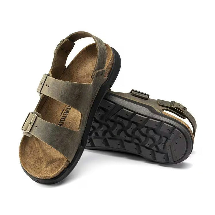 Brown Birkenstock Milano Crosstown sandals with black soles on a white background