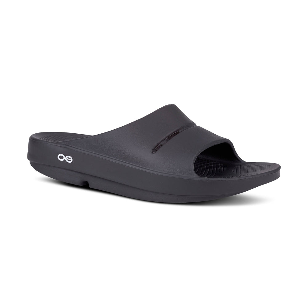 Black OOfos OOahh slide sandal on a white background