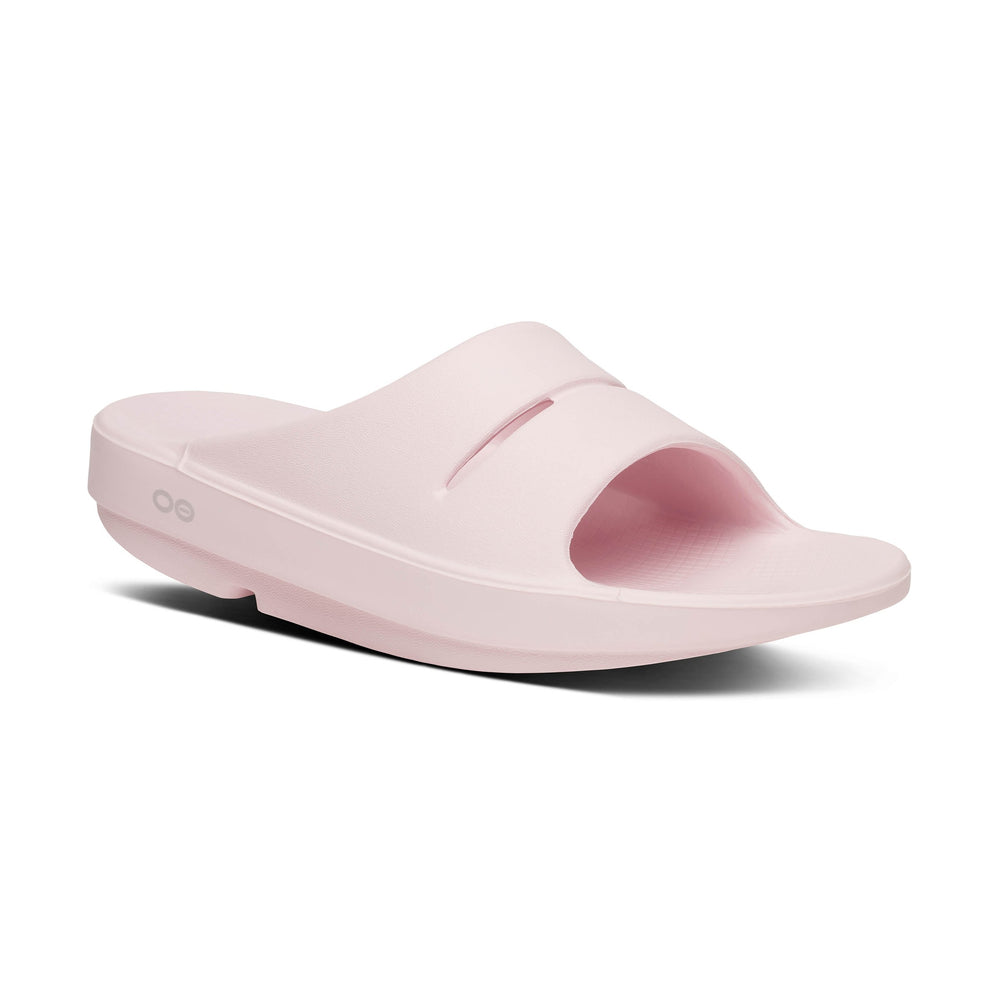 Pink OOfos OOahh slide sandal on a white background