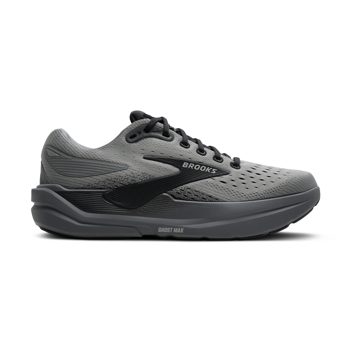 A black Brooks Ghost Max 3 – Men's  with three white stripes, featuring a textured mesh upper, black laces, and clear turf studs, shown against a light gray background.