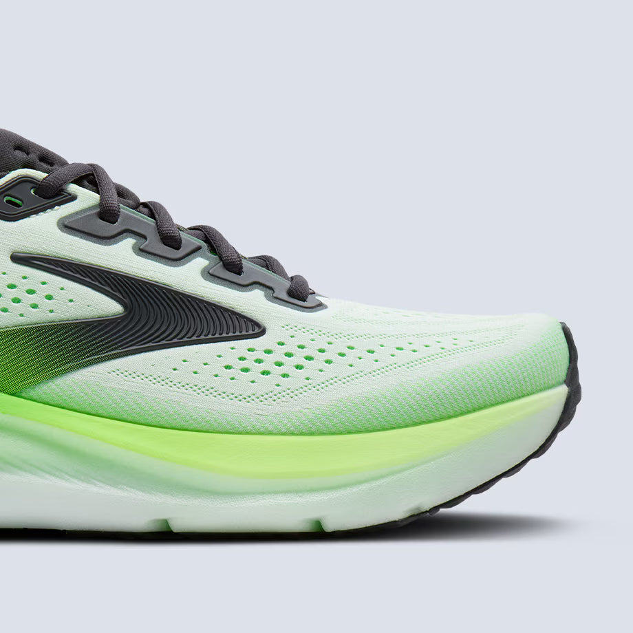 Close-up of a Brooks Glycerin GTS 23 running shoe with a white and green sole on a light gray background