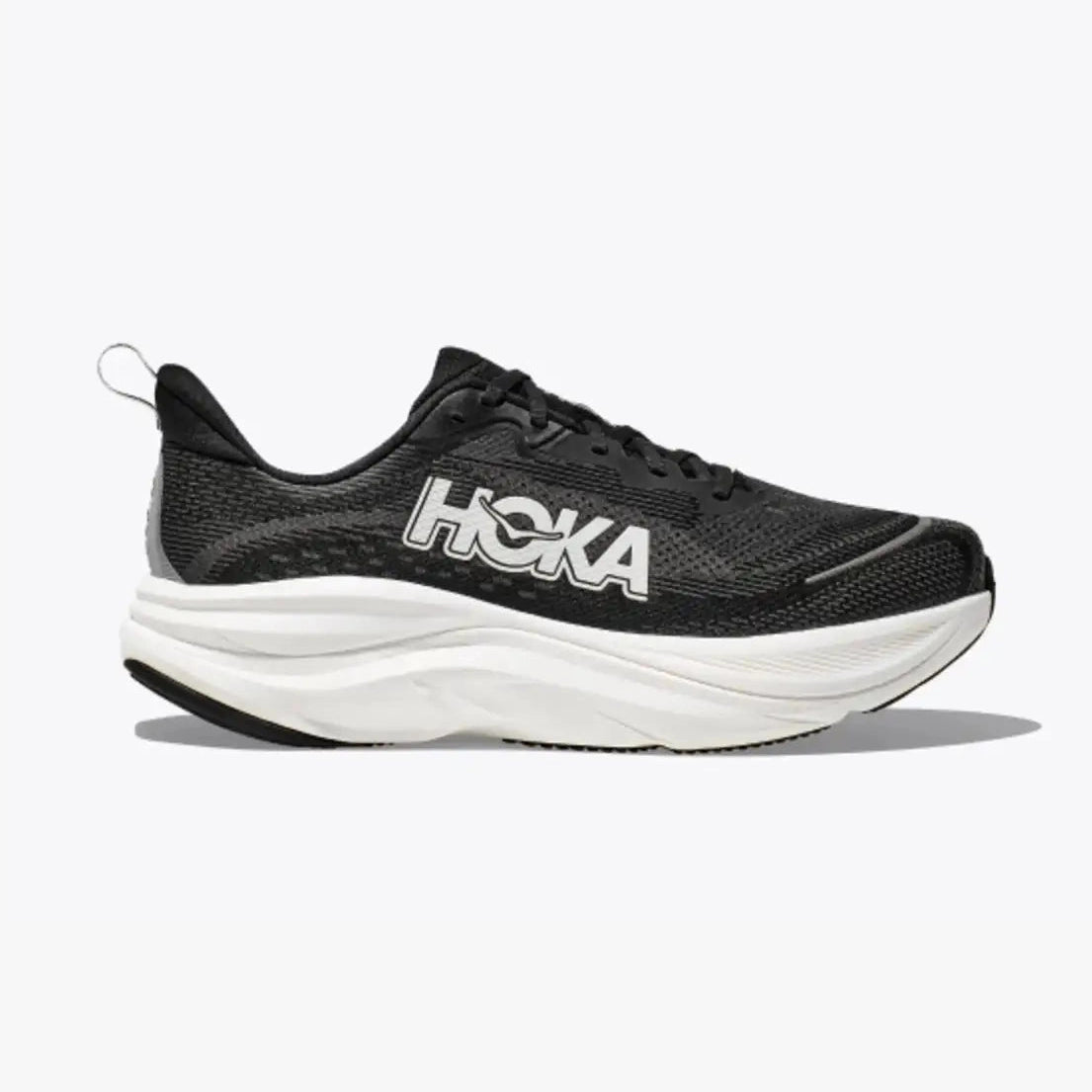 A black Hoka Skyflow – Men's running shoe with a thick white sole, shown in a side profile on a light gray background.