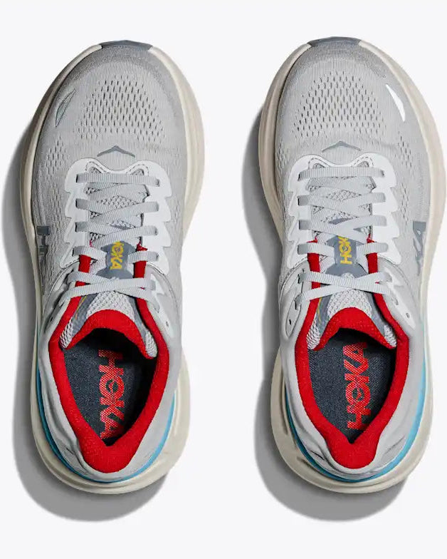 Gray and red running shoes with 'On' branding on a white background