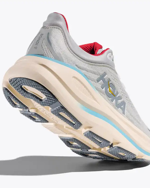 Gray running shoe with a white sole on a light gray background