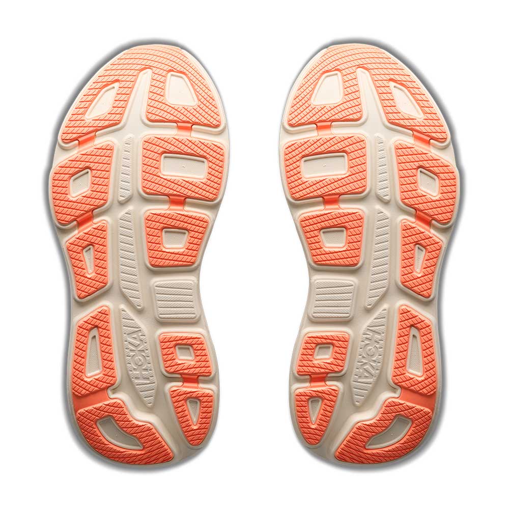Close-up of the sole of a running shoe with orange and beige pattern on a white background