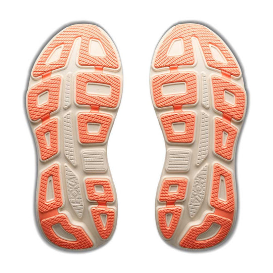 Close-up of the sole of a running shoe with orange and beige pattern on a white background