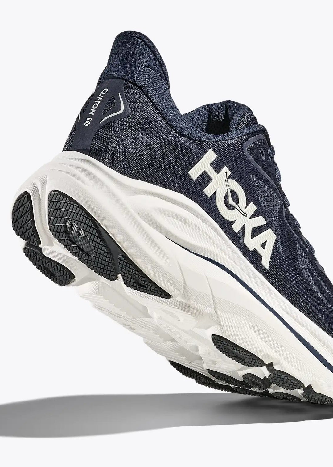 Navy Hoka Men's Clifton 10 running shoe with white sole on a light gray background