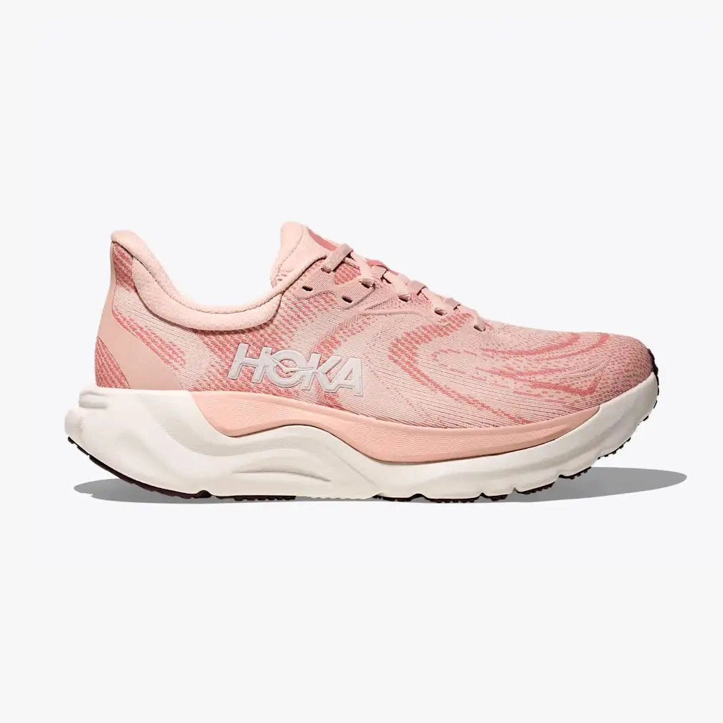 A Hoka Arahi 8 – Women's running shoe in light pink and white, shown from the side against a light gray background.