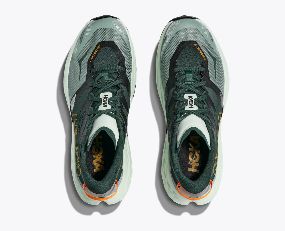Pair of green Hoka Speedgoat 7 – Men's running shoes with orange accents on a white background