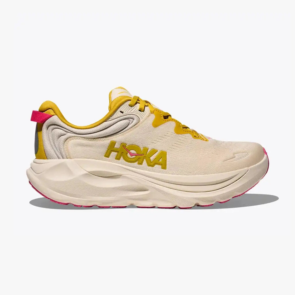 A Hoka Gaviota 6 – Women's running shoe in off-white and yellow with a bright pink heel pull tab and outsole accent, shown in a side profile on a light gray background.