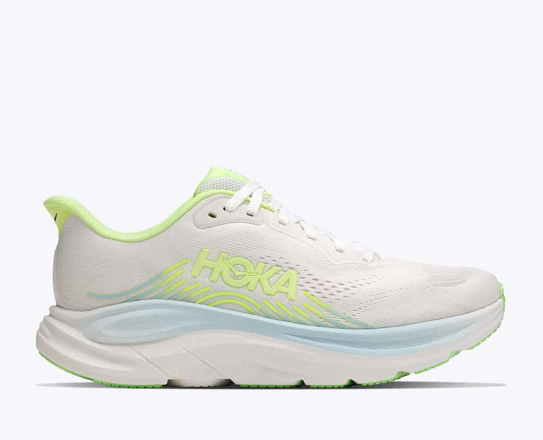 White running shoe with green accents on a white background