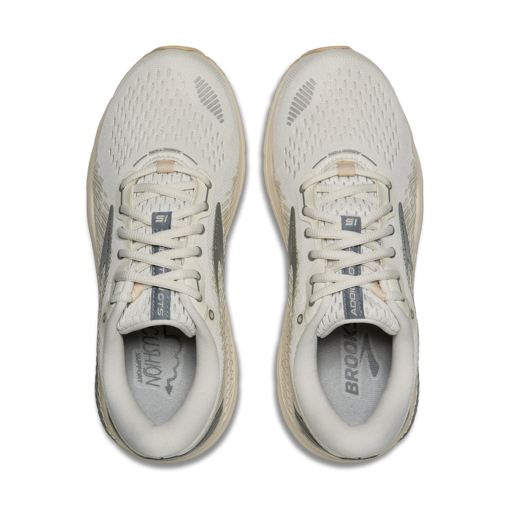 Pair of white W ADDICTION GTS 15 running shoes with visible branding on a white background