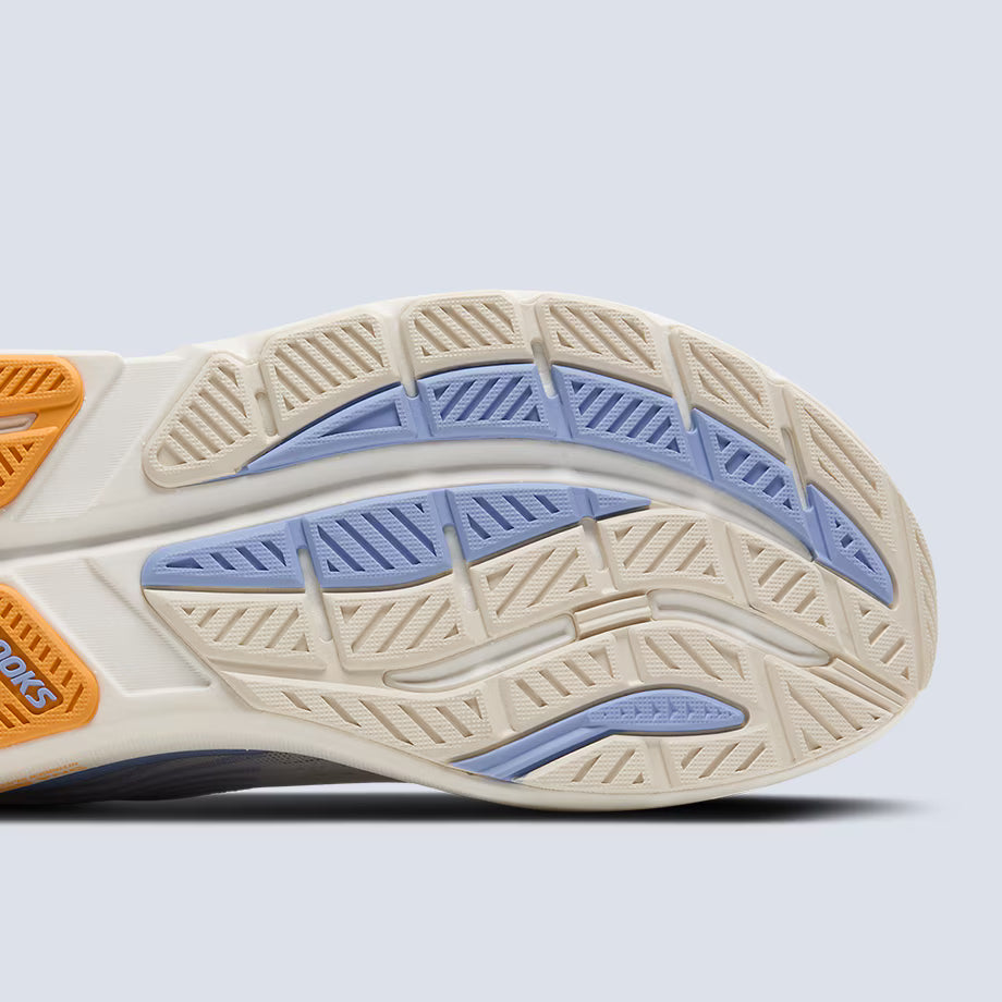 Close-up of a Brooks Ghost Max 3 running shoe's sole with orange, blue, and beige colors on a light gray background