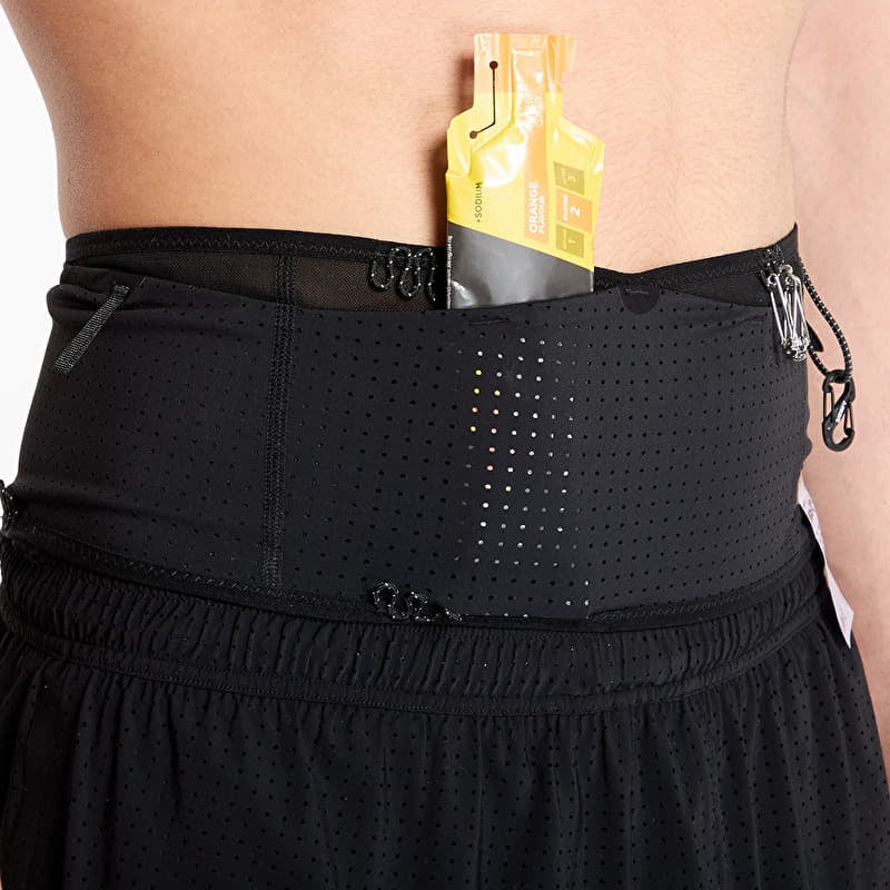 Close-up of a black Space-O Belt--All Gender worn by a model, with a yellow and black G-1000 energy drink packet tucked into the front pocket.