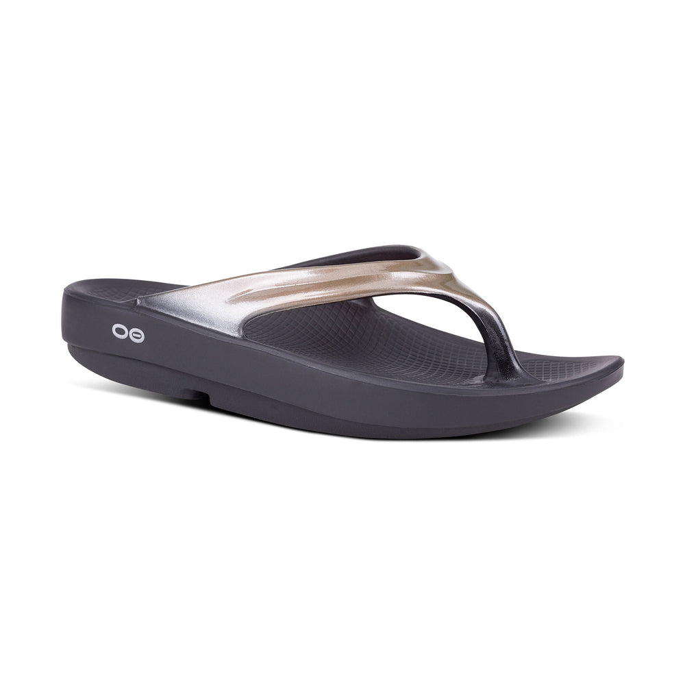 Latte OOfos OOlala sandal with a metallic strap on a white background