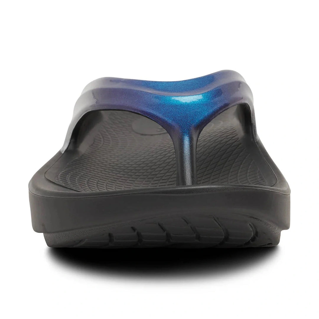 Black Oofos OOLALA sandal with blue metallic heel on a white background