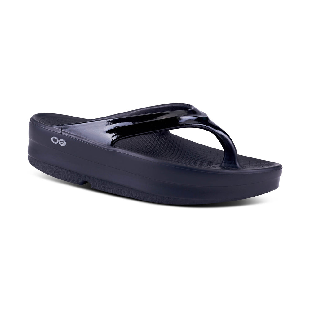 Black OOfos OOmega Thong sandal with a brand logo on a white background