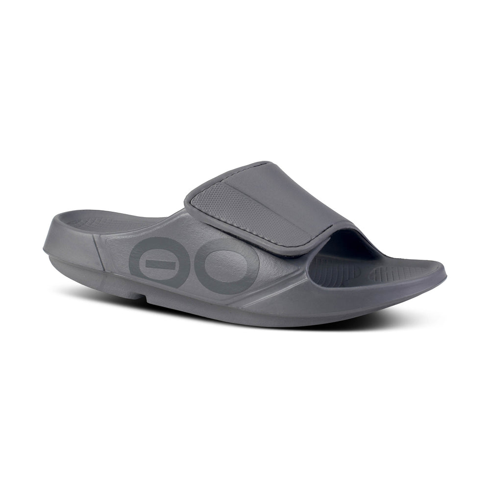 Gray OOfos OOahh Sport Flex slide sandal with a strap on a white background