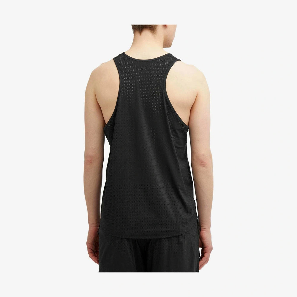 A man viewed from the back wearing a black Space-O Singlet--Men's with a textured, perforated mesh pattern and black athletic shorts against a light gray studio background.