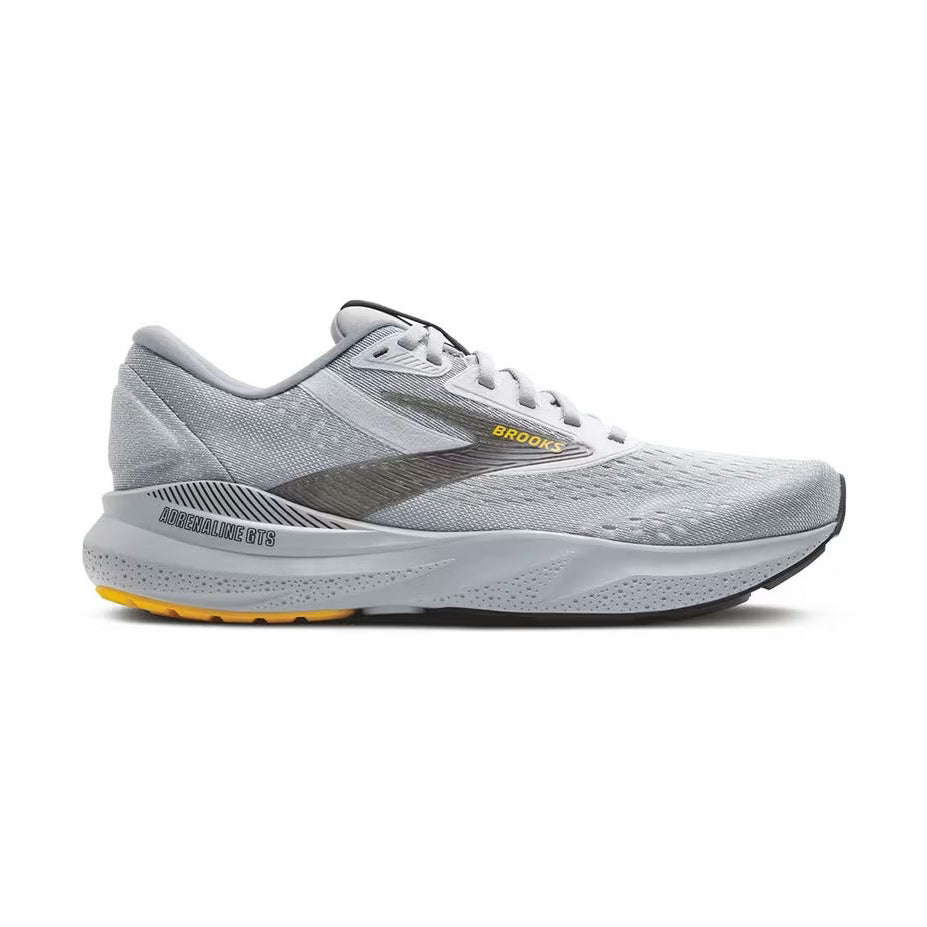 Brooks Adrenaline Gts 24 – Men's running shoe in light gray and white with a dark gray side stripe, yellow 'BROOKS' text, and a yellow outsole accent, shown from the side on a white background.