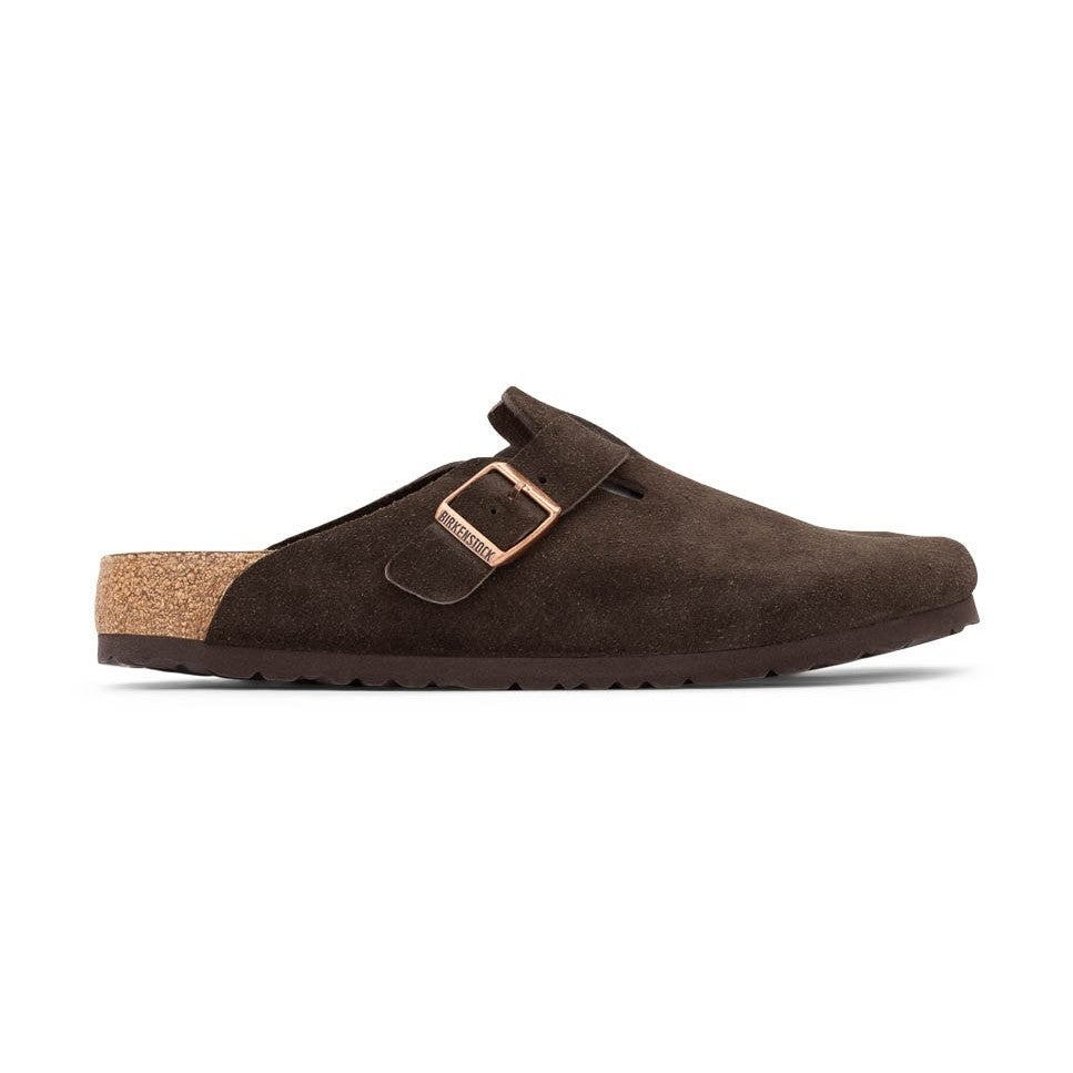 A dark brown suede Birkenstock Boston Soft Footbed clog shoe with a metallic rose gold buckle strap and a natural cork heel, shown in profile against a white background.