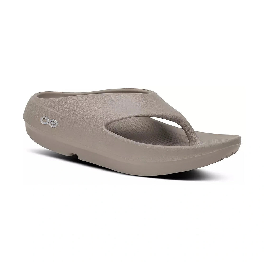 A single taupe-colored foam OOfos OOriginal PLUS sandal shown from a three-quarters perspective on a white background.