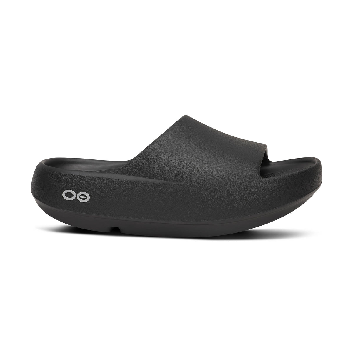 Black OOfos OOah PLUS sandal on a white background