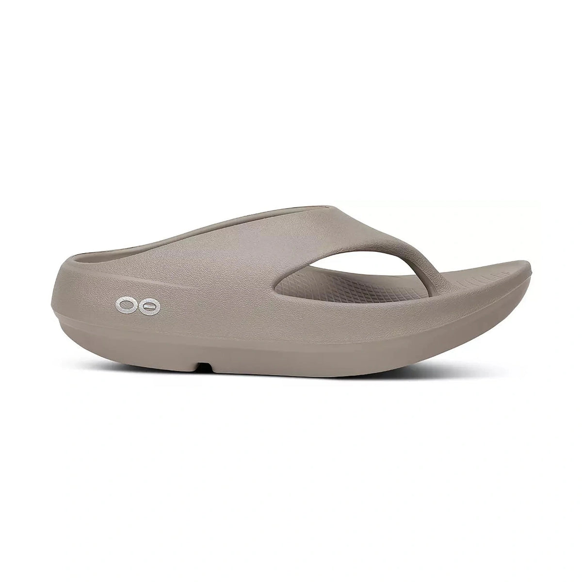 A single light taupe OOfos OOriginal PLUS foam slide sandal shown from a side profile view against a white background.