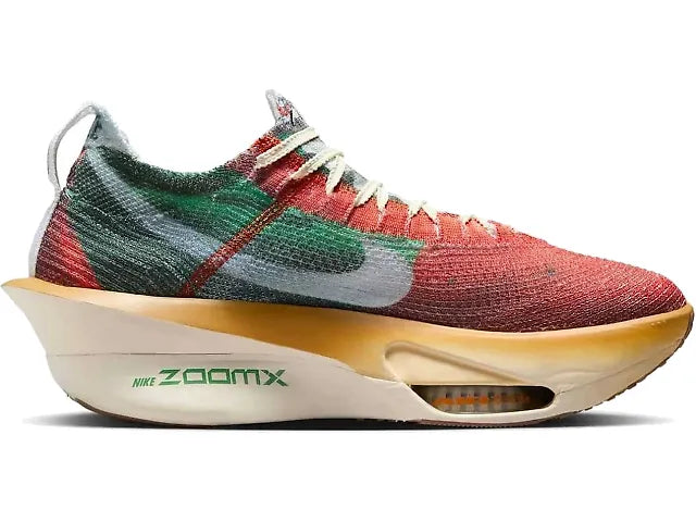 A Nike Alphafly 3 Premium – Men's sneaker with a knit upper in red, green, and gray, featuring a thick beige and gold midsole with green 'Nike ZoomX' branding.