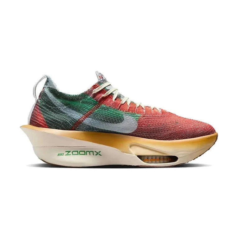 A Nike Alphafly 3 Premium – Men's sneaker with a knit upper in red, green, and gray, featuring a thick beige and gold midsole with green 'Nike ZoomX' branding.