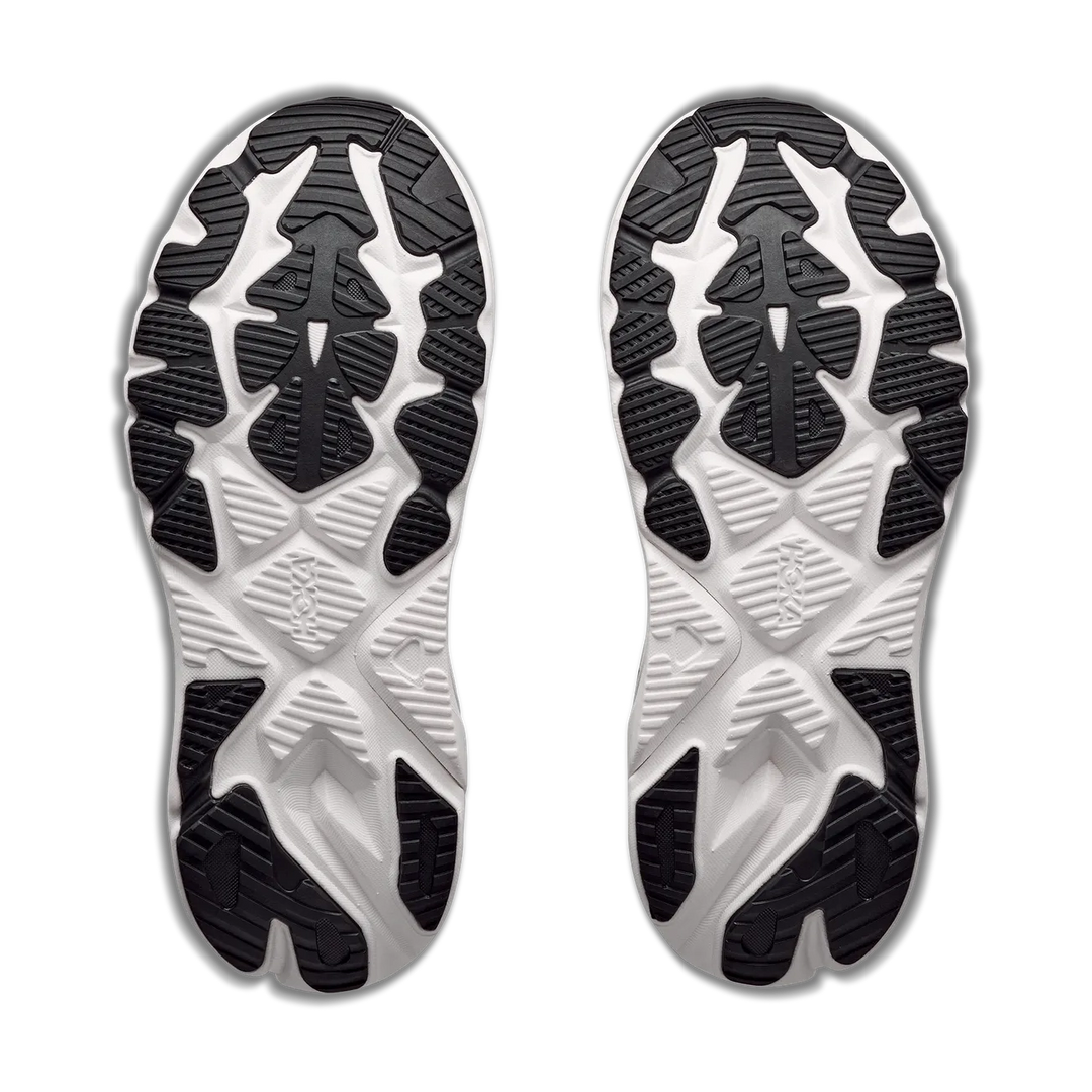 A pair of athletic shoe soles shown from the bottom, featuring a black and white treaded design on a clean white background.