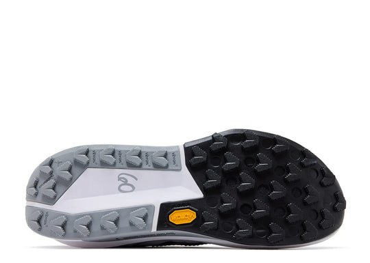 The outsole of a running shoe, showing a black Vibram tread with a small yellow accent, a white midsole section with a gray logo, and a gray outsole.