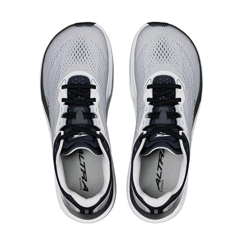 A pair of Altra Torin ST 9 – Men's running shoes shown from a top-down view, featuring a light gray and white mesh upper with black laces and black accents.