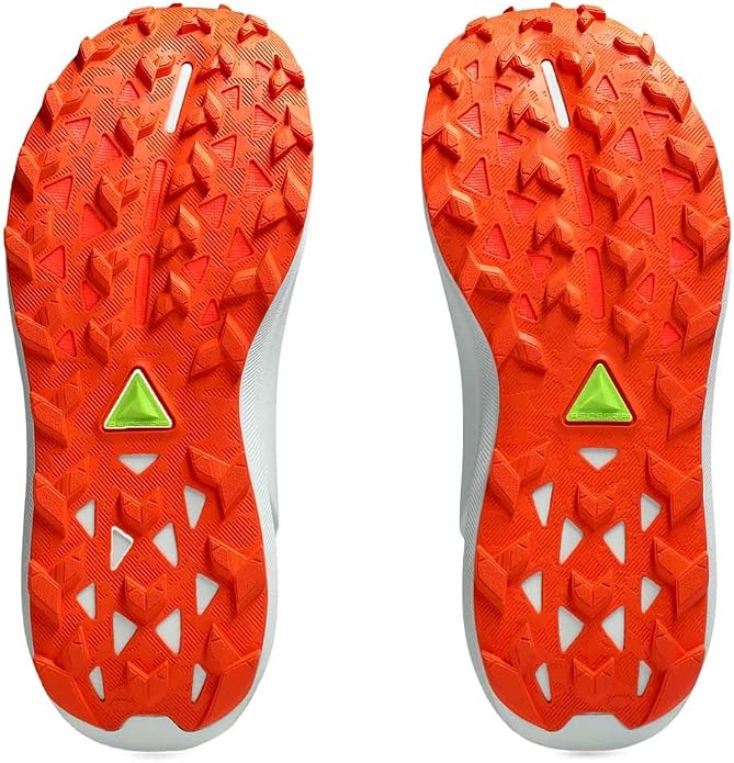 The outsoles of a pair of Gel Trabuco 13 trail running shoes, showing bright orange textured tread patterns, white sidewalls, and a small lime green triangular logo near the heel.