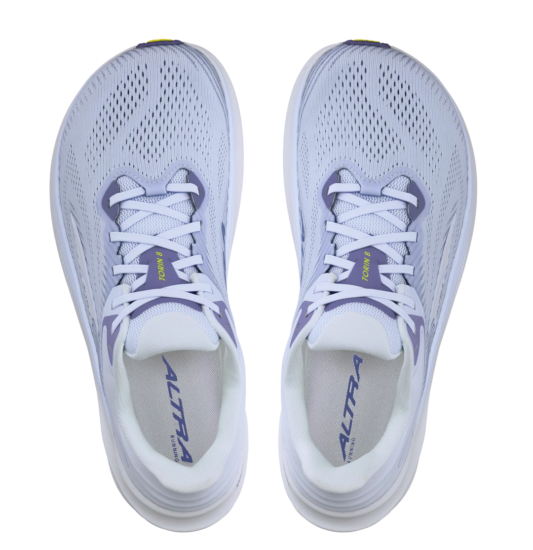 White running shoes with purple accents on a white background