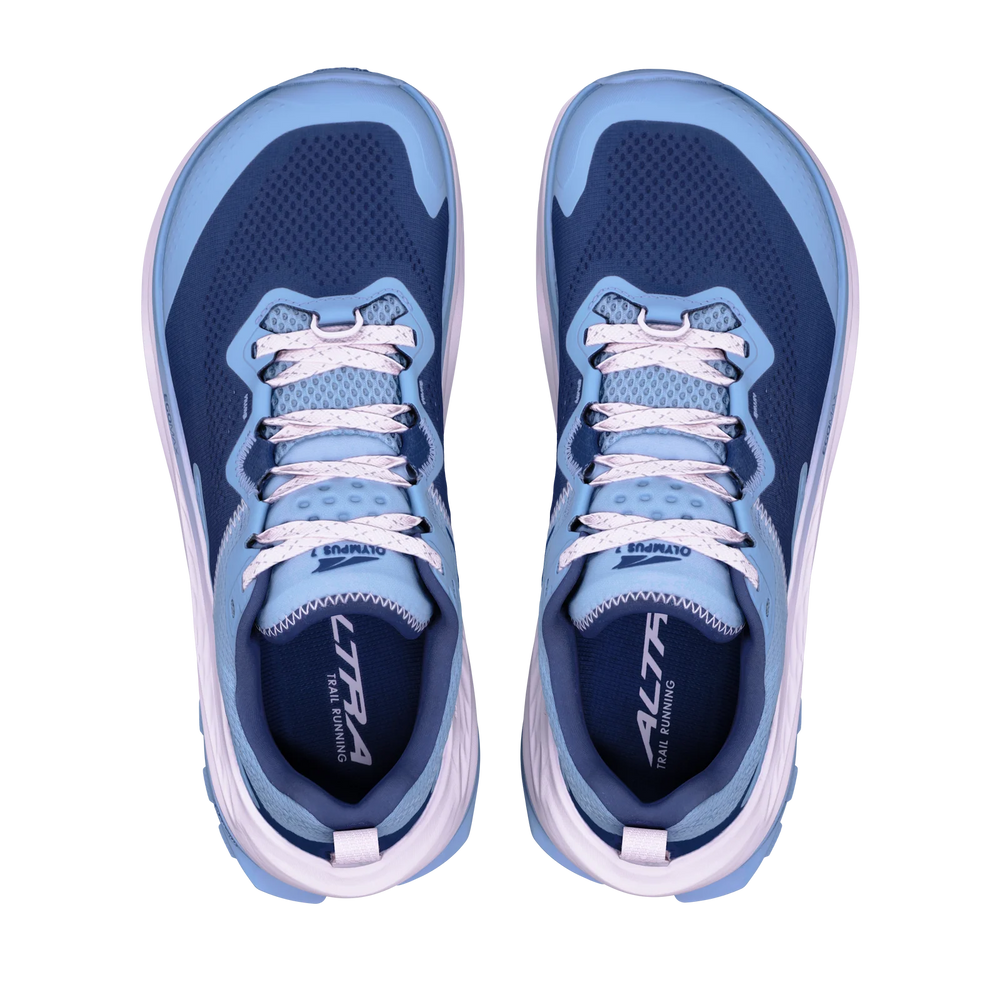 Olympus 7 a women's pair of Altra running shoes shown from a top-down view on a solid white background. The shoes feature a navy blue mesh upper with light blue overlays, white laces, and a white and light blue sole.