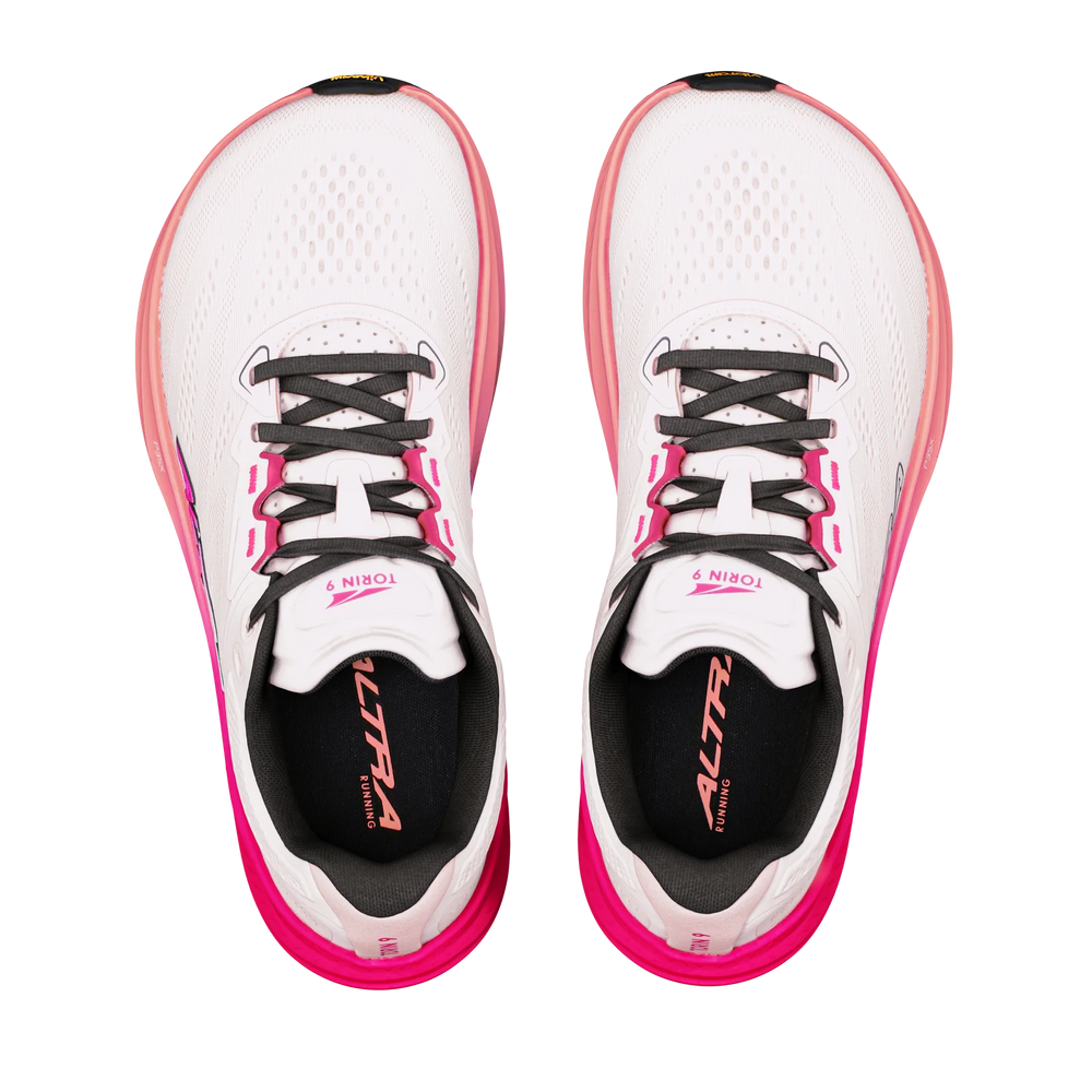 Torin 9 a women's pair of white and pink running shoes shown from a top-down view on a solid white background. The shoes feature black laces, a black inner lining, and pink accents along the midsole and collar.