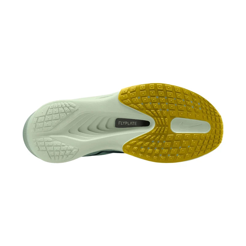 Close-up of a shoe sole with yellow and green design on a white background
