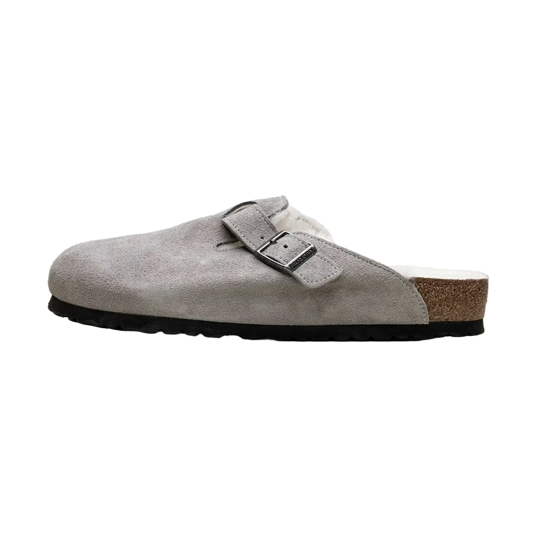 Gray suede Birkenstock Boston Shearling--Suede Stone Coin clog shoe with a buckle on a white background