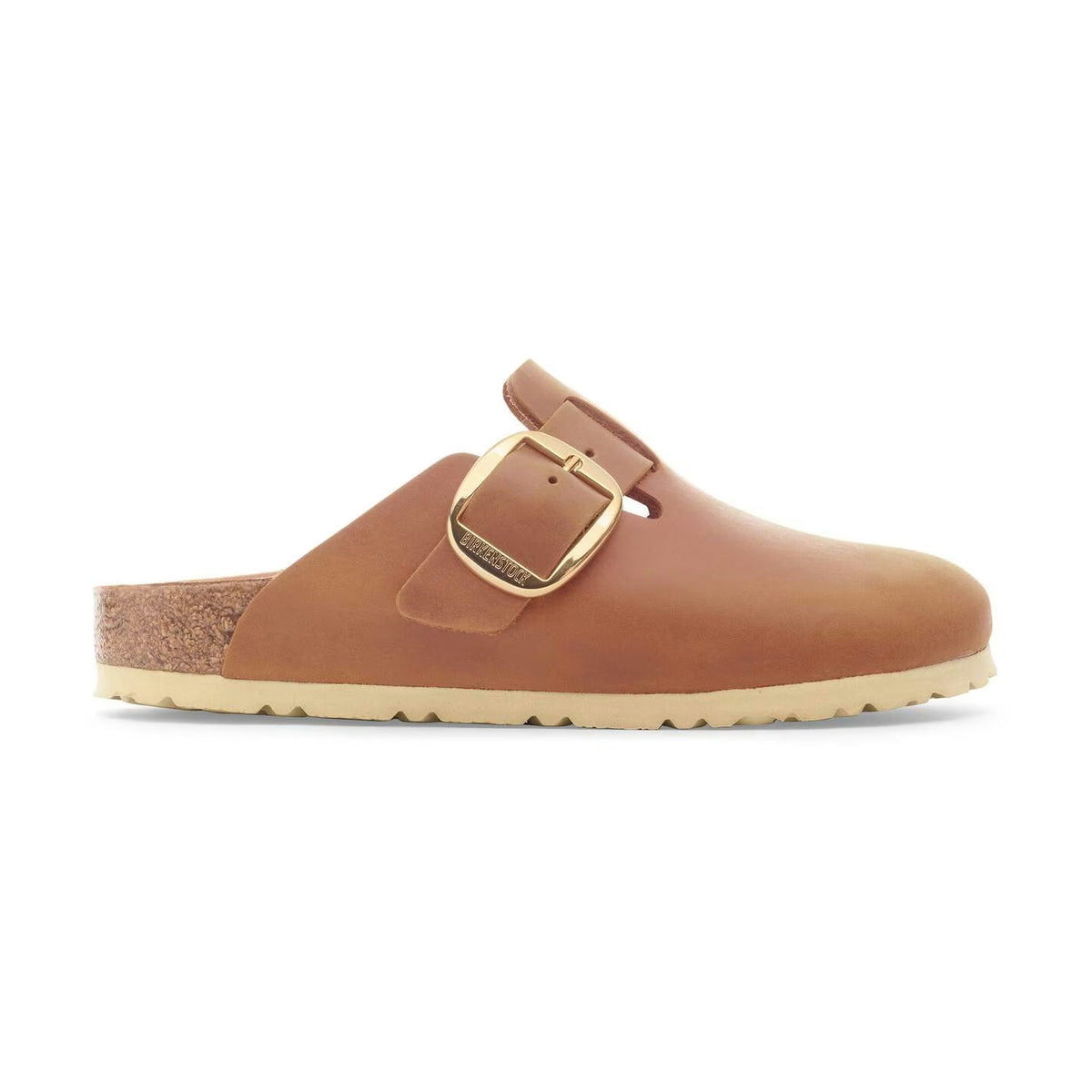 A single tan leather clog-style Birkenstock Boston Big Buckle with a gold-tone buckle strap and a cork footbed, shown in profile against a plain white background.
