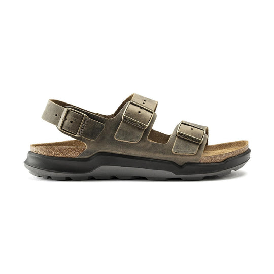 A single Birkenstock Milano Crosstown sandal in a distressed brown leather with a cork footbed and a black sole, shown from a side profile view on a white background.