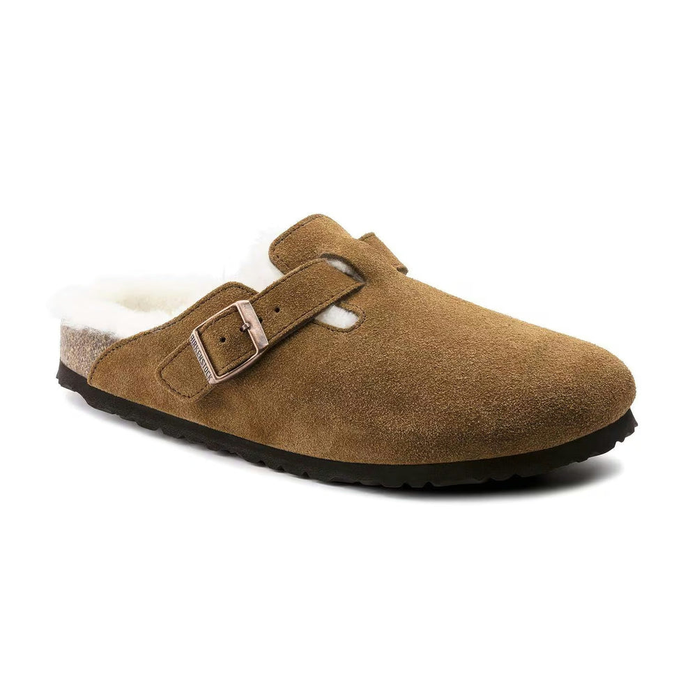 A tan suede clog-style Birkenstock Boston Shearling with a white shearling lining and a rose gold buckle, shown from a three-quarters angle on a white background.