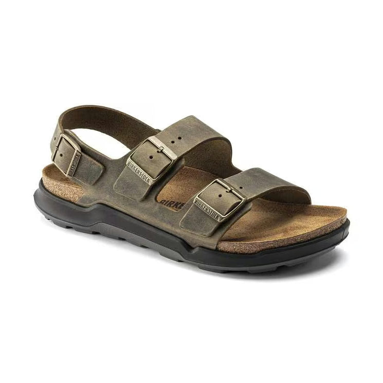 A single Birkenstock Milano Crosstown sandal in distressed olive brown leather with a black outsole, shown from a three-quarters angle on a white background.